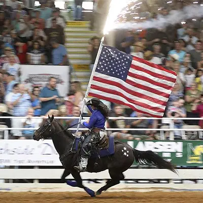 Southeastern Pro Rodeo Woman riding a horse with an American flag